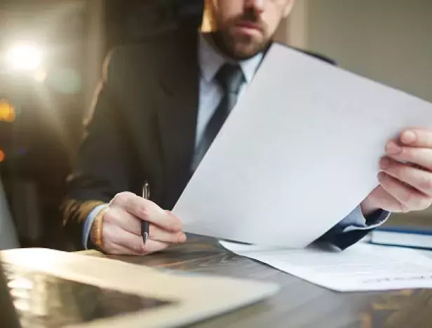 businessman-working-with-documentation-at-desk