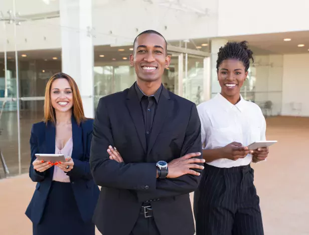 happy-cheerful-business-people-posing-in-office-hallway