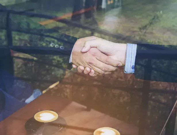 two-businessman-shake-hand-coffee-shop