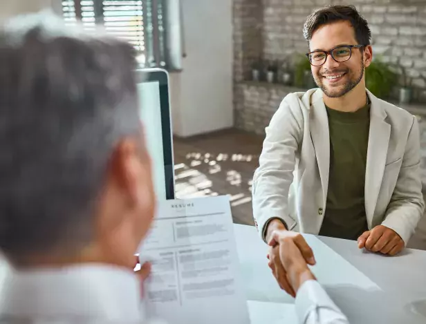 happy-male-candidate-greeting-member-human-resource-team-job-interview-office